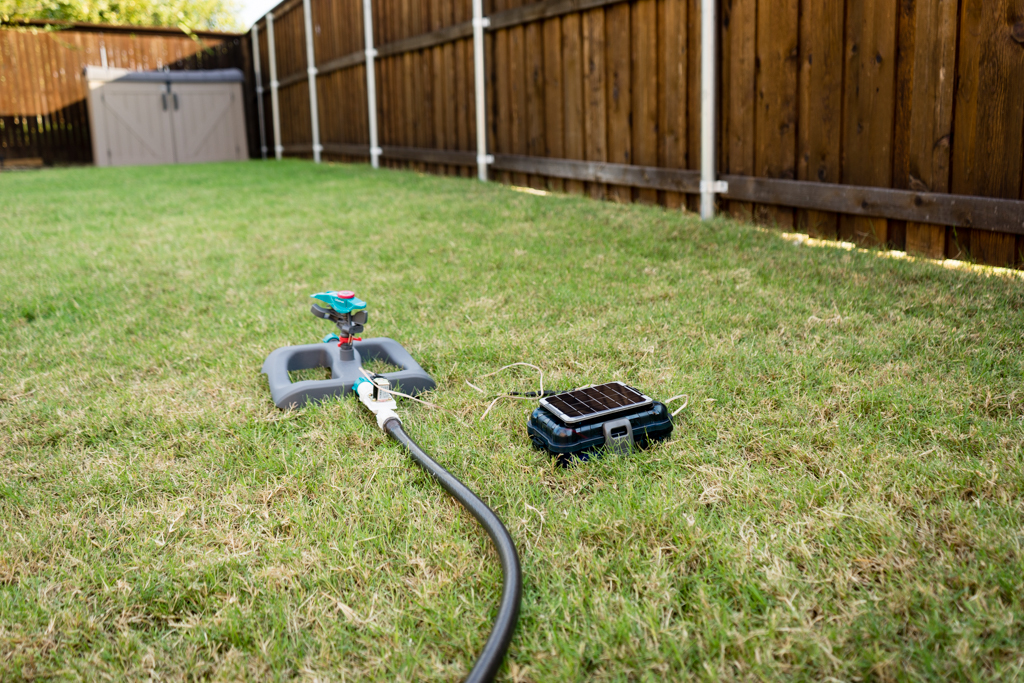 Solar powered automatic sprinkler on lawn.