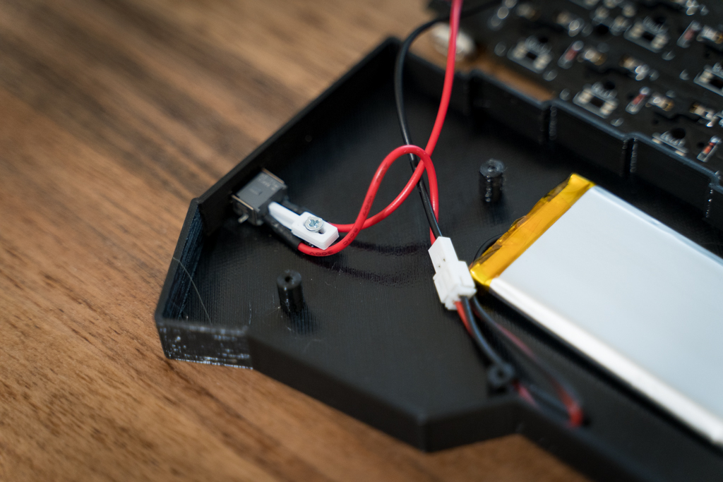 Battery and connectors. Note the white switch securing pin screwed into a standoff in the case.