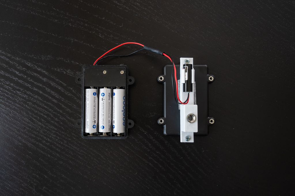 Laser emitter showing open battery compartment.