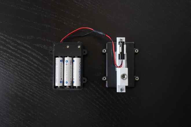 Laser emitter showing open battery compartment.