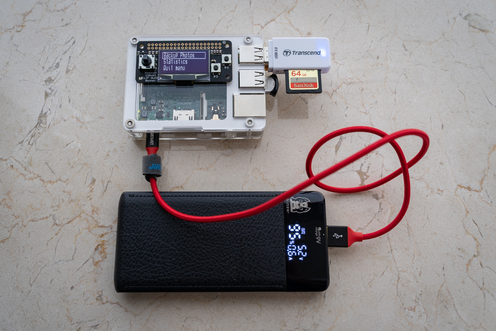Menu on OLED screen shown on Raspberry Pi 3 powered by a portable battery.